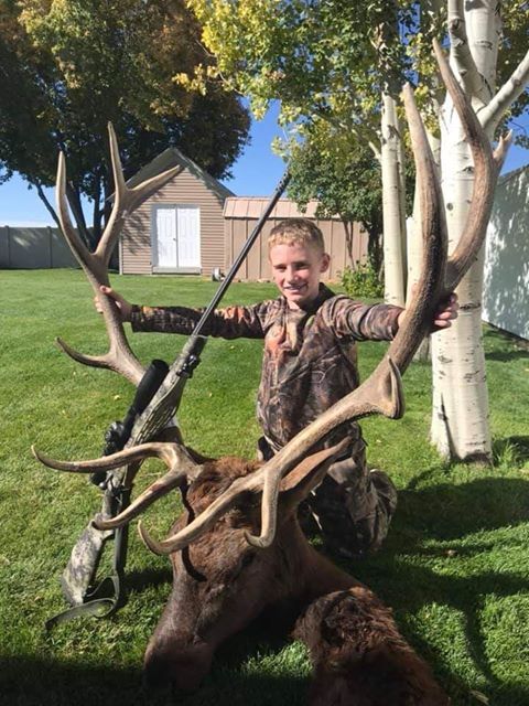 Boy elk hunting with Quigley Ford long range scope